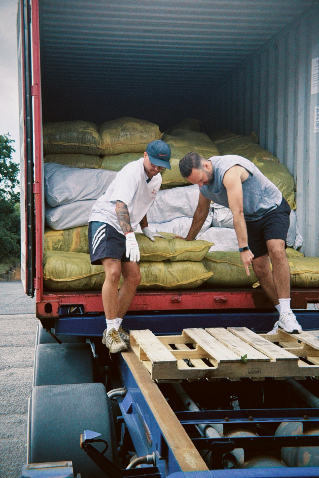 Opening a container filled with vintage clothing stock